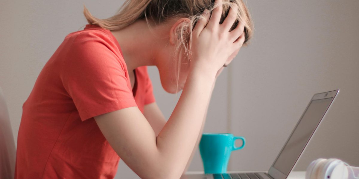 A person feeling overwhelmed by too many choices on streaming services, experiencing choice overload bias.