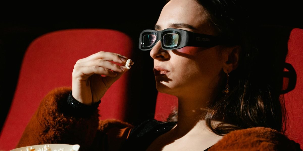 A person completely absorbed in an intense movie, reflecting the suspenseful and thrilling nature of the films.