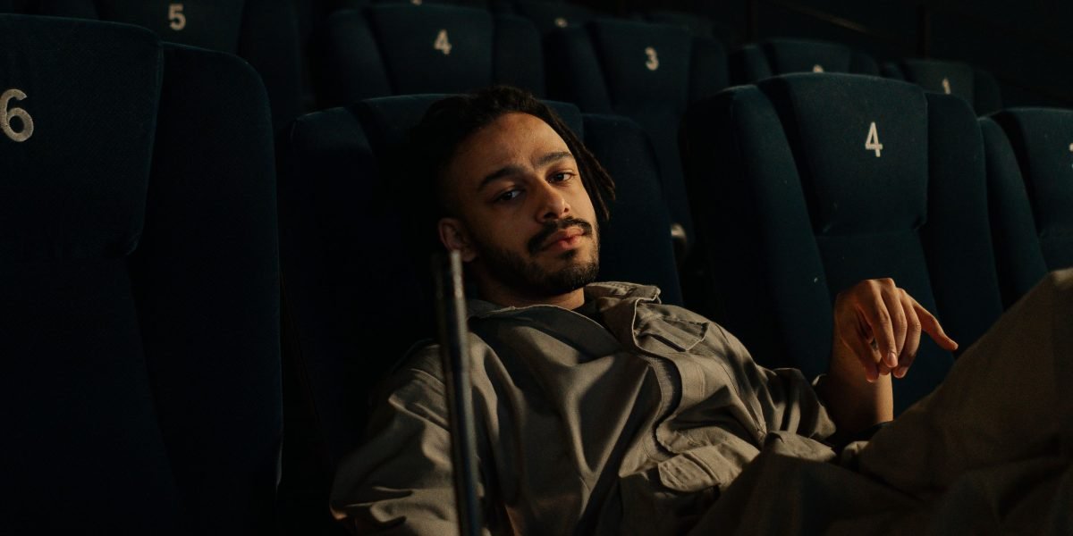 Someone carefully considering their movie choice, matching the film's tone to their desired mood and taste.