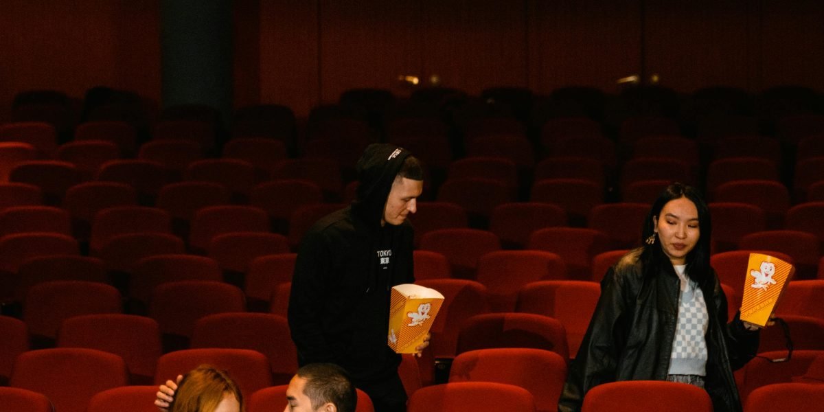 A group of friends or a couple relaxing and enjoying a curated movie together during a special movie night.